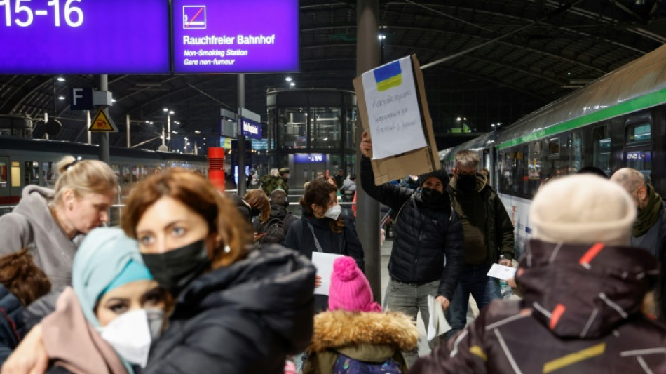 Tired and emotional, Ukrainians arrive by train in Berlin