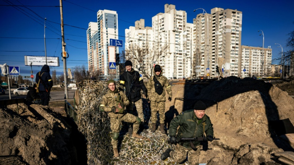 Russia strikes Ukrainian cities as troops mass near capital