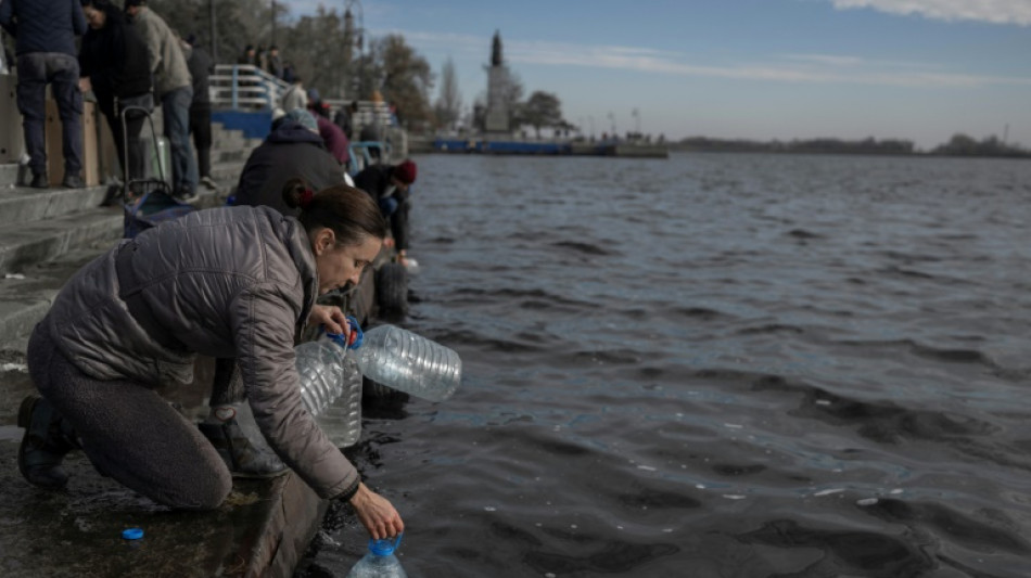 Kherson residents seek water and phone service on river's edge